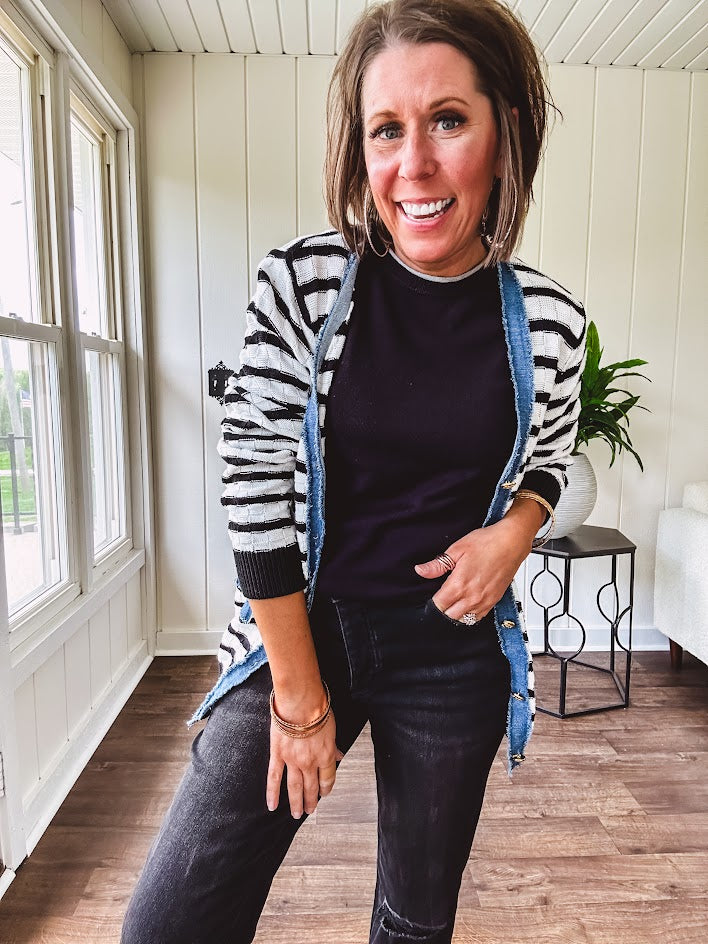 Soft black round neck sweater tank with faux grey layering trim at the neck and hem.