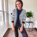 Lightweight black and white striped cardigan with checkered texture, denim raw edge trim at the placket and on the two faux front pockets with gold buttons.