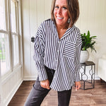 Oversized muted black and white striped button down long sleeved top with front pocket and white buttons.