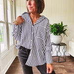 Oversized muted black and white striped button down long sleeved top with front pocket and white buttons.