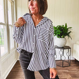 Oversized muted black and white striped button down long sleeved top with front pocket and white buttons.