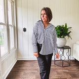 Oversized muted black and white striped button down long sleeved top with front pocket and white buttons.