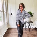 Oversized muted black and white striped button down long sleeved top with front pocket and white buttons.