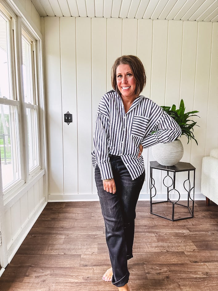 Oversized muted black and white striped button down long sleeved top with front pocket and white buttons.