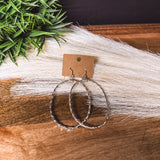 Large hammered sterling silver oval earrings on a shepherd's hook back.