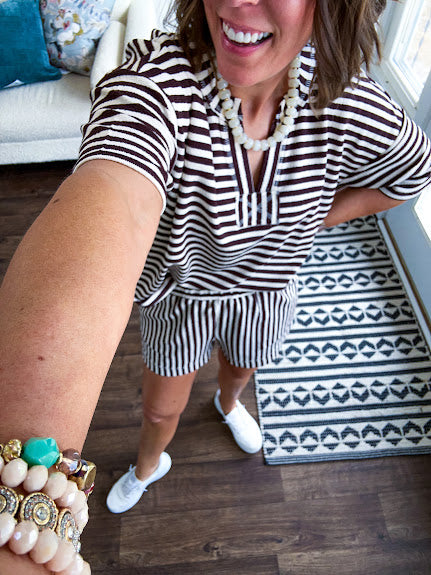 Lightweight terry-like textured fabric in cream and dark brown stripes with V neck, short sleeves and matching elastic waist shorts with pockets.