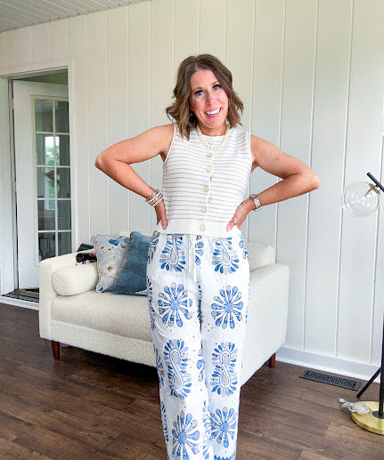 White cotton wide leg pants with denim blue sea inspired print, eyelet cutouts throughout, elastic drawstring waist and pockets with shorts lining.