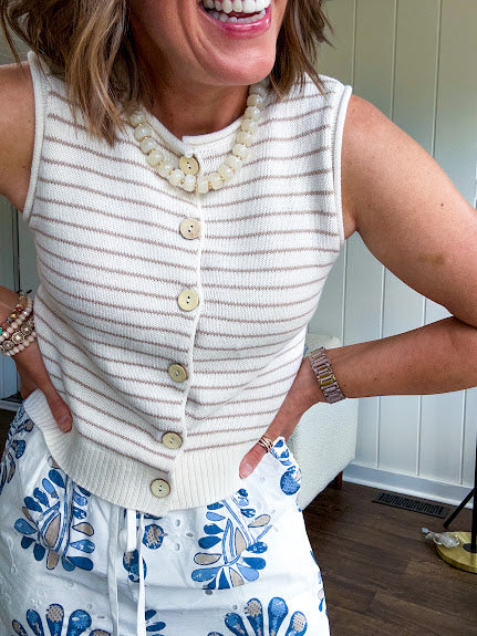 Ivory and taupe striped button down sweater vest with faux wood buttons.