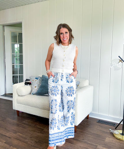 White cotton wide leg pants with denim blue sea inspired print, eyelet cutouts throughout, elastic drawstring waist and pockets with shorts lining.