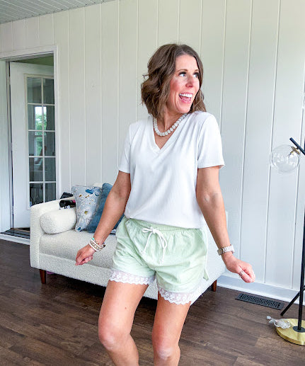 White relaxed fit V neck tee with ribbed texture and round hem.