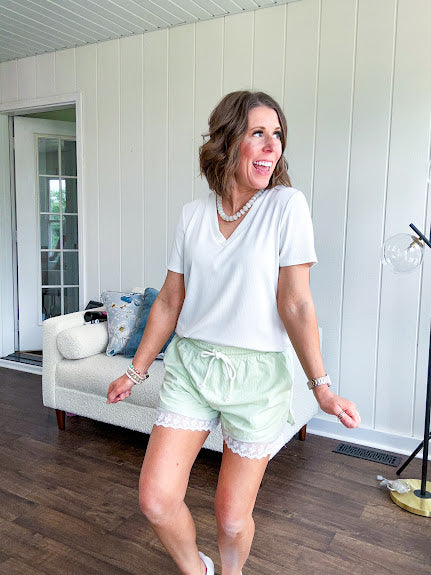 White relaxed fit V neck tee with ribbed texture and round hem.