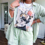 Cream cotton tee with vintage inspired graphic of Victorian woman, butterflies, flowers and rhinestones with scatterbrained phrases around the edges.