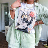 Cream cotton tee with vintage inspired graphic of Victorian woman, butterflies, flowers and rhinestones with scatterbrained phrases around the edges.