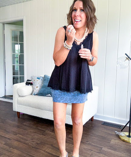 Lightweight ribbed black tank with lace trim at the V neck on the front and back with lace strip across the back and lace trim at the flowy hem.