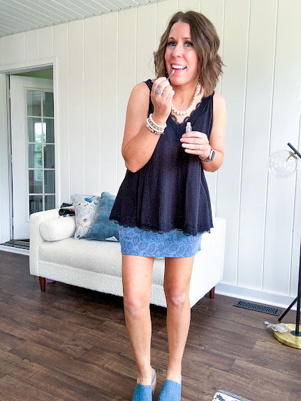 Lightweight ribbed black tank with lace trim at the V neck on the front and back with lace strip across the back and lace trim at the flowy hem.