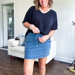 Soft knit denim blue skort with shorts lining, elastic waist and pockets with paisley print throughout.