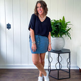 Soft knit denim blue skort with shorts lining, elastic waist and pockets with paisley print throughout.
