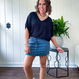 Soft knit denim blue skort with shorts lining, elastic waist and pockets with paisley print throughout.