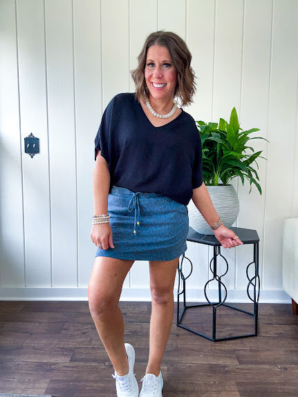 Lightweight and flowy black V neck dolman style short sleeved top.