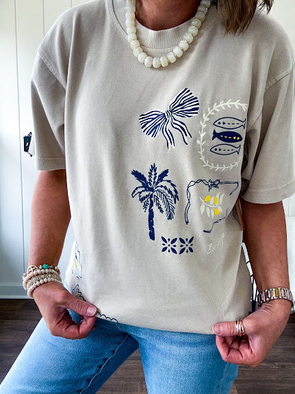 Taupe cotton tee with navy, yellow and white ocean-inspired graphics.