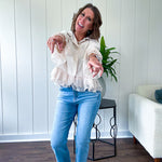Thin, lightweight beige button down cropped jacket with collar, ruffled hem and ruffle at the cuffs with texture.