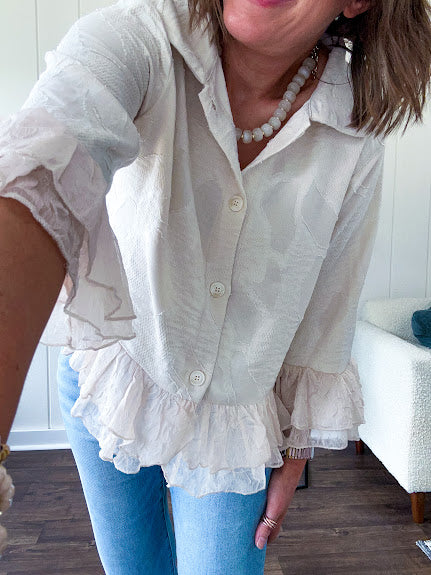 Thin, lightweight beige button down cropped jacket with collar, ruffled hem and ruffle at the cuffs with texture.