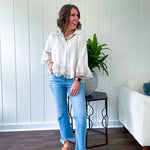Thin, lightweight beige button down cropped jacket with collar, ruffled hem and ruffle at the cuffs with texture.