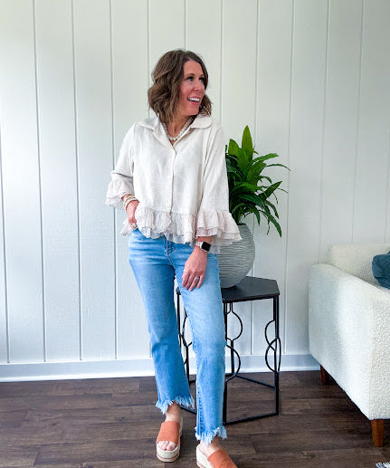 Thin, lightweight beige button down cropped jacket with collar, ruffled hem and ruffle at the cuffs with texture.