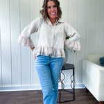 Thin, lightweight beige button down cropped jacket with collar, ruffled hem and ruffle at the cuffs with texture.