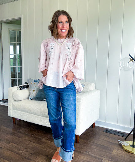 Cotton nearly sheer blouse with 3/4 sleeves, floral beading and eyelet detail throughout, ruffled neckline and flowy hem.