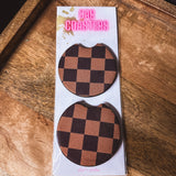 Two black and brown checkered neoprene car coasters.