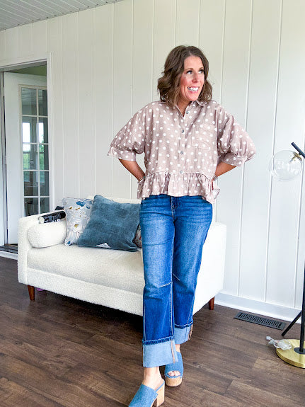 Light, flowy sand colored button down top with collar, 3/4 cuffed sleeves and front pocket with seam detail and ruffled hemline.