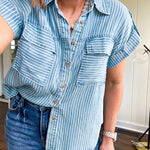 Light chambray button down top with white stripe detail, tab sleeves and front pockets.