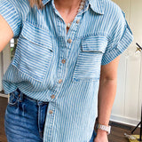 Light chambray button down top with white stripe detail, tab sleeves and front pockets.