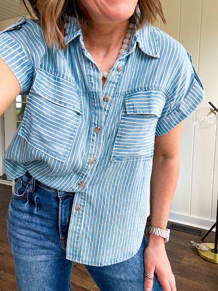 Light chambray button down top with white stripe detail, tab sleeves and front pockets.