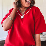 Soft, cool red Modal fabric shorts with elastic drawstring waist, wide hem and piping down the sides with pockets.