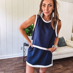 Cool navy buttery soft skirt with shorts lining, elastic waist, pockets and contrasting white trim down the sides and on the split hem.
