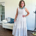This mocha plaid midi dress is your new summer obsession. The smocked bodice hugs in all the right places while the tiered, flowy skirt does the twirling for you. Ruffled straps and trim add that playful touch that makes heads turn, and the slip lining keeps things cool and comfortable from brunch to sunset.