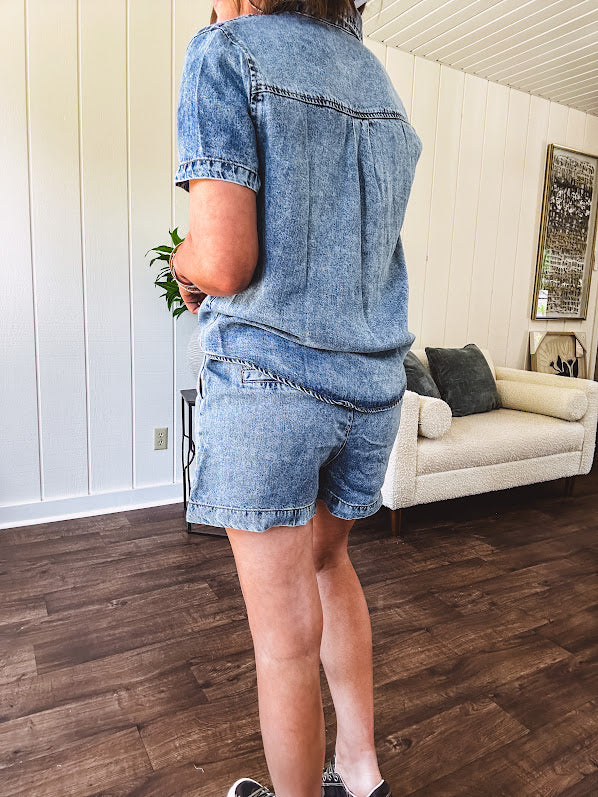 Medium wash chambray denim button down top with front pockets, collar and short sleeves with matching elastic waist shorts with pockets.