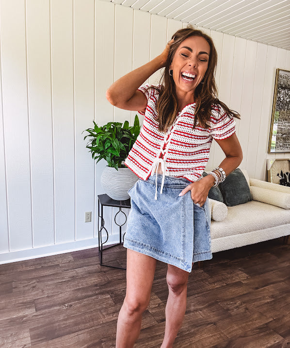 Thin, light wash denim skort with pointed hem and pockets.