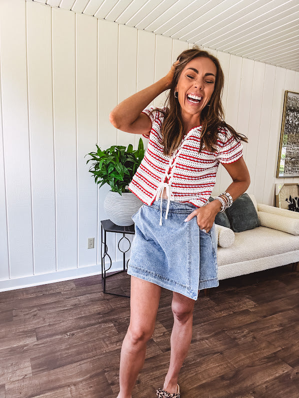 Thin, light wash denim skort with pointed hem and pockets.