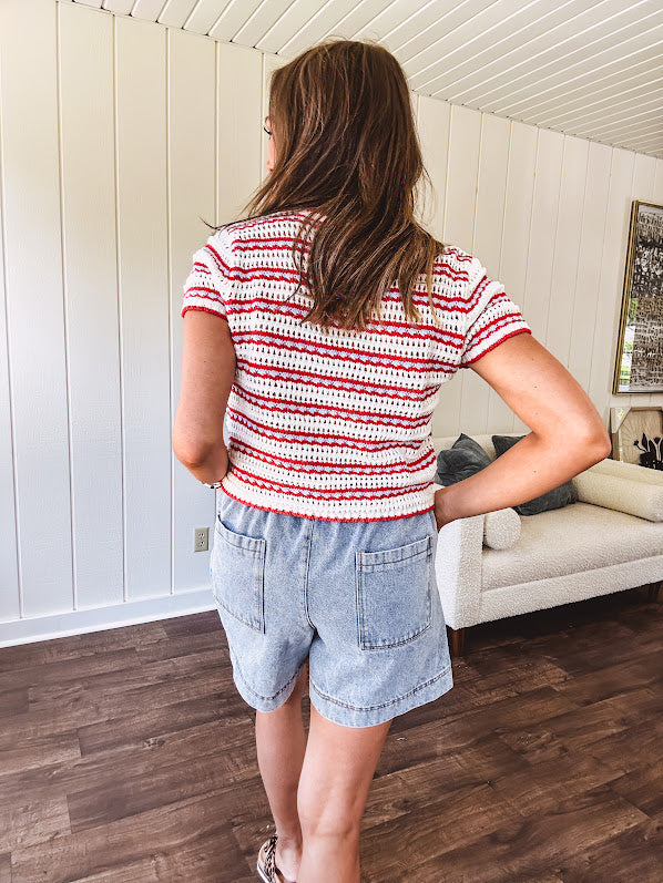 Thin, light wash denim skort with pointed hem and pockets.