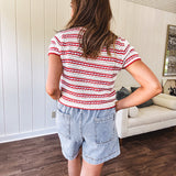 Soft crochet knit red, white and light blue striped short sleeved tie front sweater.