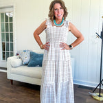 This mocha plaid midi dress is your new summer obsession. The smocked bodice hugs in all the right places while the tiered, flowy skirt does the twirling for you. Ruffled straps and trim add that playful touch that makes heads turn, and the slip lining keeps things cool and comfortable from brunch to sunset.