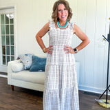 This mocha plaid midi dress is your new summer obsession. The smocked bodice hugs in all the right places while the tiered, flowy skirt does the twirling for you. Ruffled straps and trim add that playful touch that makes heads turn, and the slip lining keeps things cool and comfortable from brunch to sunset.