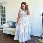 This mocha plaid midi dress is your new summer obsession. The smocked bodice hugs in all the right places while the tiered, flowy skirt does the twirling for you. Ruffled straps and trim add that playful touch that makes heads turn, and the slip lining keeps things cool and comfortable from brunch to sunset.