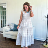 This mocha plaid midi dress is your new summer obsession. The smocked bodice hugs in all the right places while the tiered, flowy skirt does the twirling for you. Ruffled straps and trim add that playful touch that makes heads turn, and the slip lining keeps things cool and comfortable from brunch to sunset.