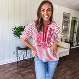 Lightweight cotton white and berry striped 3/4 sleeve top with berry trim at the mock neck and V neck and embroidery at the yoke with elastic cuffs and loose hem.