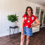 Bold red sweater vest with silver fuzzy stars throughout.