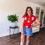 Bold red sweater vest with silver fuzzy stars throughout.